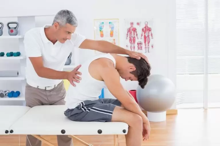 A chiropractor talking with a new patient
