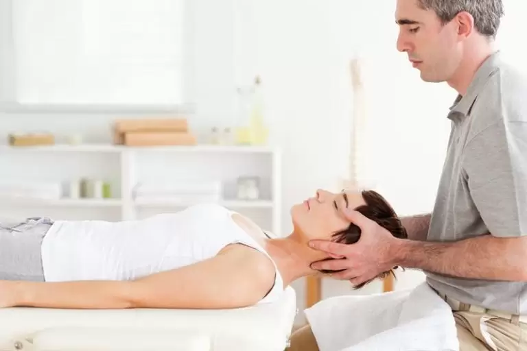 A chiropractor adjusting a patient’s back