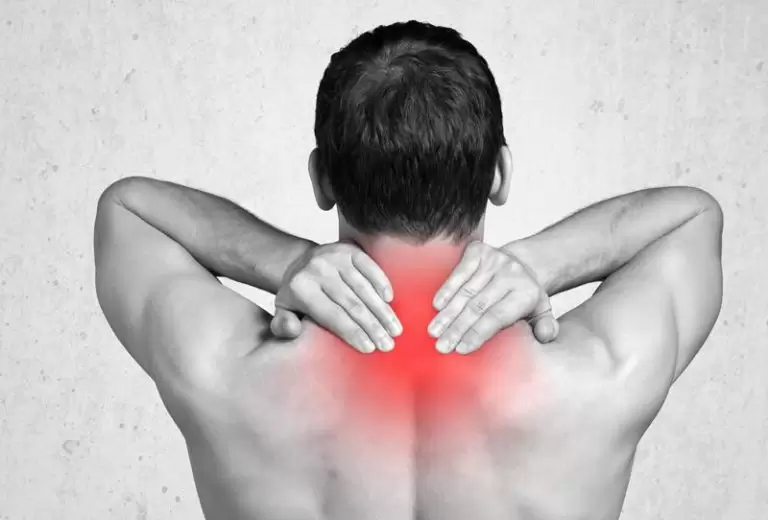 A chiropractor examining a patient’s neck