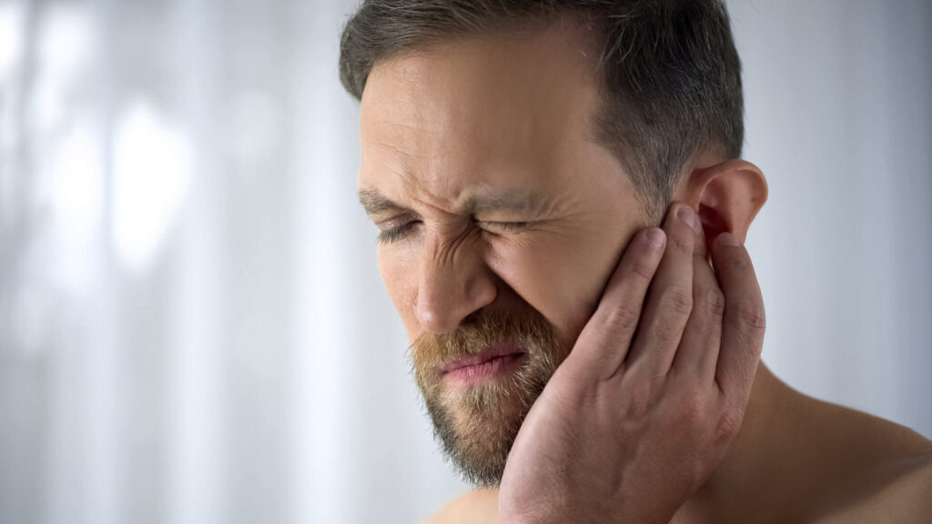 A woman holding her jaw