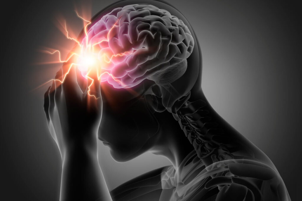 A woman with a headache, holding her temples