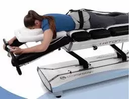 A patient lying face down on the decompression table