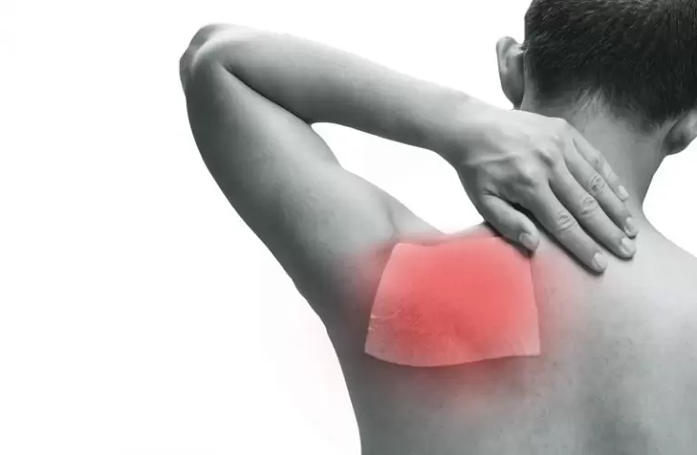 A man holding his sore shoulder