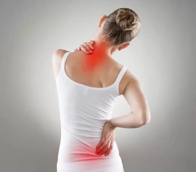 A worker holding his upper and lower back