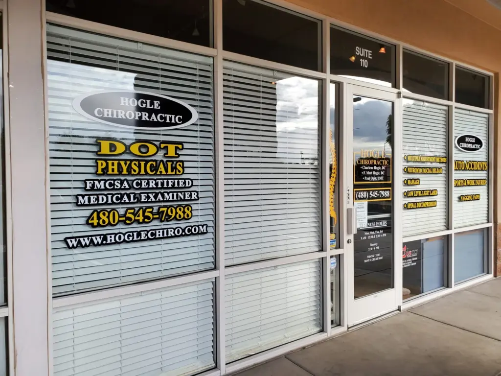 The office door, Suite 110, with gold window lettering: Hogle Chiropractic, DOT physicals, FMCSA certified medical examiner, (480) 545-7988